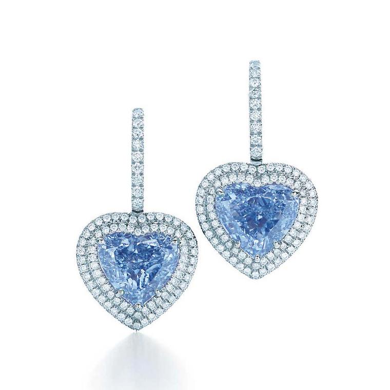 This exceptionally rare pair of heart-shaped Fancy Vivid blue diamond earrings from Tiffany & Co. are set in platinum and surrounded by round brilliant white diamonds.